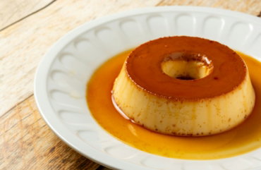 a small dessert on a white plate on a wooden table