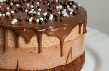 chocolate cake with white icing on white ceramic plate